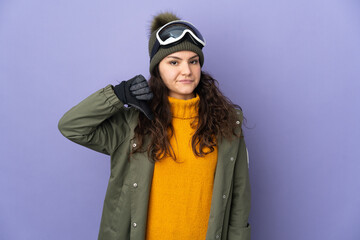 Teenager Russian girl with snowboarding glasses isolated on purple background showing thumb down with negative expression