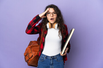 Teenager student isolated on purple background with surprise expression