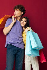 portrait of a man and a woman shopping bags in hand isolated background unaltered