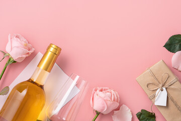 Valentine's Day gift with wine and pink rose bouquet on pink background.