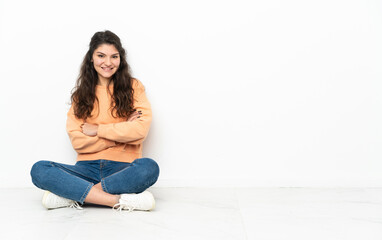 Teenager Russian girl sitting on the floor laughing