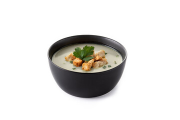 Garlic soup topped with croutons in black bowl isolated on white background
