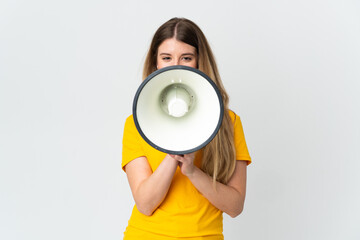 Young blonde woman isolated on white background shouting through a megaphone to announce something