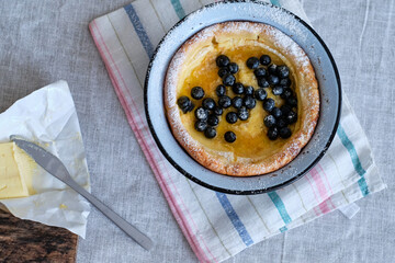 Dutch pancake with blueberries and powdered sugar. Top view.