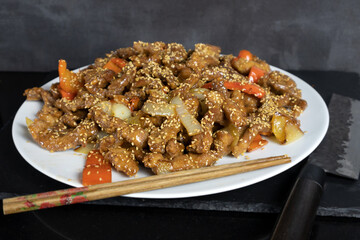 pork loin with sweet and sour sauce, asian recipe with chopsticks