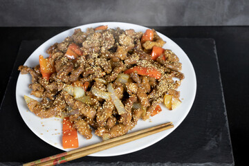 pork loin with sweet and sour sauce, asian recipe with chopsticks