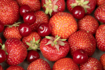 Mix of ripe strawberries and cherries