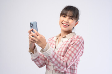 Young beautiful woman using smart phone isolated on white background
