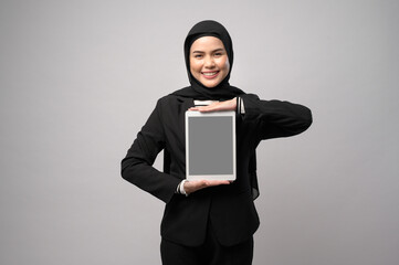 Portrait of young beautiful muslim businesswoman  is holding tablet over white background studio