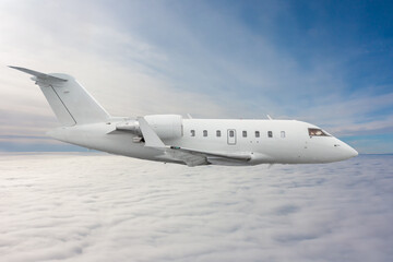 White modern luxury executive business jet flies in the air above the clouds