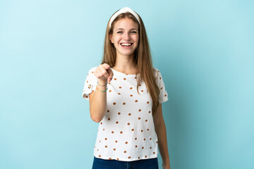 Young caucasian woman over isolated background surprised and pointing front