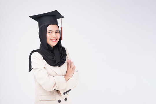 Young muslim woman graduated over white background studio..