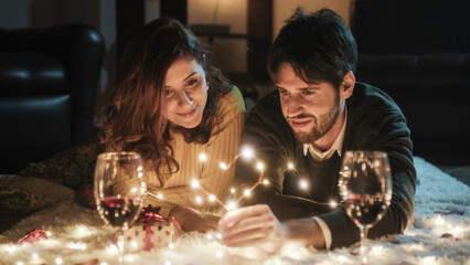 Young couple boy and girl on white carpet in Valentine's day