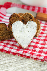 Heart shaped rye toasts with cream cheese