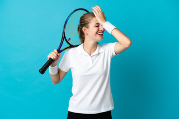 Young woman tennis player isolated on blue background has realized something and intending the solution