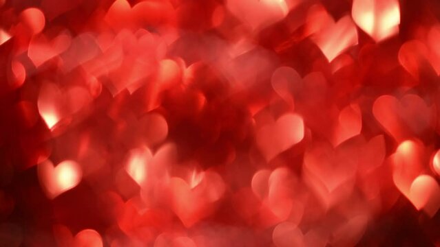 4k Valentines Day background. Red hearts movement with sparkling and shining. Can be used as backdrop or holiday overlay. Light leaks as a lens bokeh in a shape of heart abstract move.