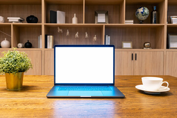 Computer laptop with white screen on the table at home.