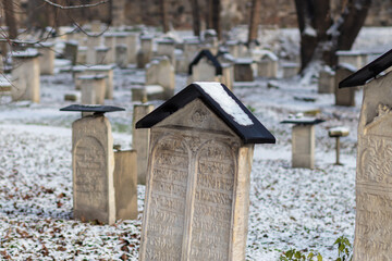 Snow-covered gravestones in the old Jewish cemetery in the Kazimierz Krakow neighborhood