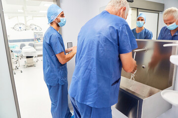Obraz premium Surgeons team washing hands for disinfection