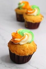 Tiranga Cupcake or Tricolor Cupcake with Indian National Flag colors frosting. saffron or orange, white and green. The concept for Indian happy Independence or Republic day greeting card. copy space.