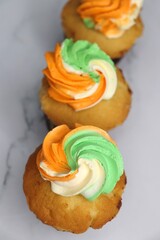 Tiranga Cupcake or Tricolor Cupcake with Indian National Flag colors frosting. saffron or orange, white and green. The concept for Indian happy Independence or Republic day greeting card. copy space.