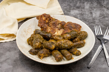 Meat leaf wrapping. Traditional Mediterranean flavor. Wrapping leaves on a dark background. local name etli yaprak sarma