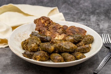 Meat leaf wrapping. Traditional Mediterranean flavor. Wrapping leaves on a dark background. local name etli yaprak sarma