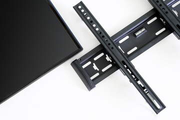 Wall metal bracket for installing a TV or monitor on a white background. The concept of mounting a...