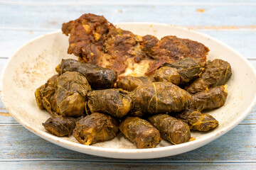 Meat leaf wrapping. Traditional Mediterranean flavor. Wrapping leaves on a blue wooden background. local name etli yaprak sarma