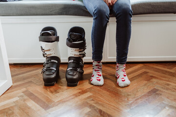 woman feet next to her are ski boots