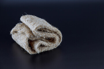 Folded rug on a black background for sowing microgreens.