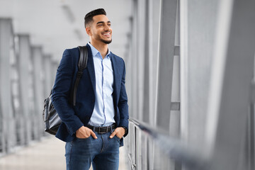 Ready For Trip. Handsome Arab Man With Backpack Standing At Airport Terminal
