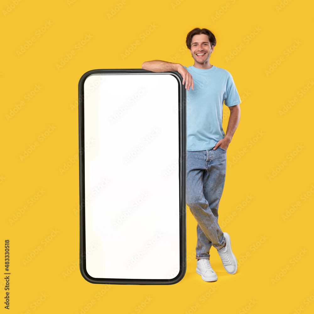 Poster man leaning on big white empty smartphone screen