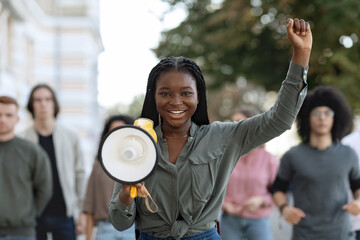 Charismatic black lady activist with megaphone on the street