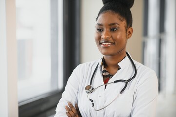 african american female doctor in hospital corridor