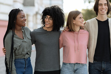 Multiracial group of cheerful millennials spending time together