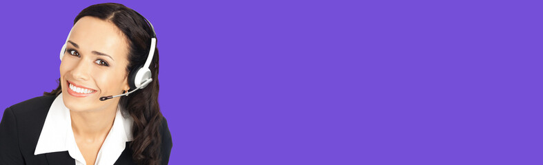 Call center service. Portrait image of female customer support phone sales operator in headset showing something or copy space area for text or slogan, over violet purple background.
