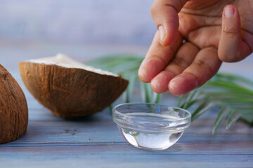 women using coconut oil on table 