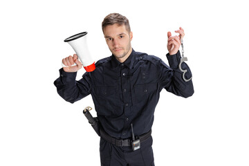 Studio shot young happy man, policeman officer wearing black uniform posing isolated on white...