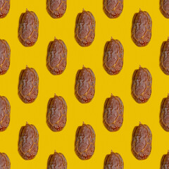 Seamless pattern with dried date fruit on yellow background.