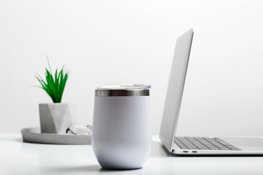 White Thermo Cup Mock Up On Modern Stylish Workplace With Laptop. Cup Mockup.