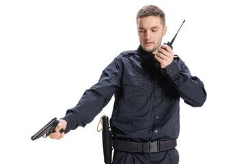 Half-length portrait of young male policeman officer wearing black uniform posing with gun isolated...