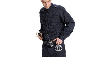 Cropped image of male policeman officer wearing black uniform with walkie-talkie and handcuffs...