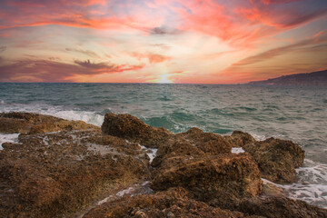 Amazing colorful sunset on the mediterranean sea in South, a rough sea.