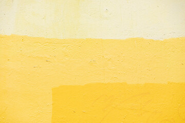 Naklejka premium Texture is yellow paint. Combination of yellow shades on wall. Surface of painted wall.
