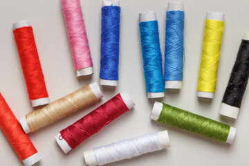 Multi-colored threads on a gray background.