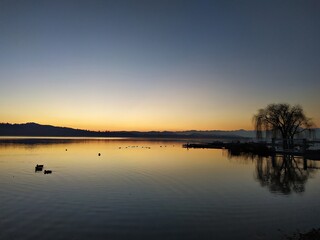 Obraz premium Italy, Varese: Sunset in Schiranna Beach.