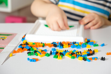 Baby's hands and mosaics. Toys for the development of fine motor skills and creative thinking.