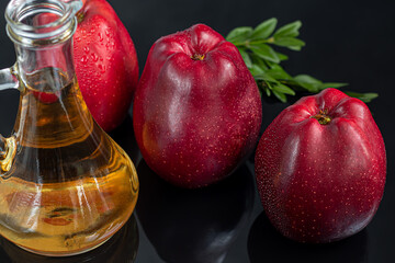 Apple cider vinegar and red apples on a dark, wooden background. Selective focus. fermented product. Healthy food.