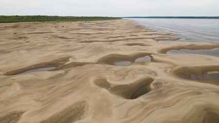 Beautiful sandy river bottom at low tide in northern Siberia on a sunny summer day